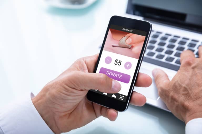 Businessman Donating Money Online On Mobile Phone